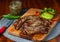 Delicious steak with green sauce and avocado