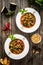 Delicious stew - aubergine with tomatoes and chickpeas on wooden table