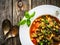 Delicious stew - aubergine with tomatoes and chickpeas on wooden table