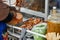 Delicious stewed ear pork at the street food. Motion blurred hand of seller chops the pork on cutting board