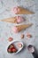 Delicious strawberry ice cream cone with fresh strawberry on marble background. top view