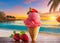 A delicious strawberry ice cream cone on a table on a tropical beach at sunrise or sunset.