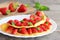 Delicious strawberry omelette. Omelette stuffed with strawberries slices and garnished with mint leaves on a plate