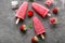 Delicious strawberry popsicle with berries on grey background