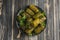 Delicious stuffed grape leaves traditional doom Mediterranean cuisine Dolma on a black plate with fresh cilantro and dill