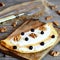 Delicious stuffed omelette. Fried omelette with cottage cheese, black currants and walnuts on wooden board