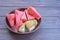 Delicious summer snack. Grilled salty Levantine halloumi cheese and slices of sweet watermelon on a wooden background.