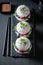 Delicious sushi burger with berries and mascarpone on dark plate