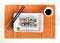 Delicious sushi rolls on white plate with chopsticks