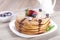 Delicious sweet American pancakes on a plate with fresh fruits