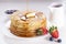 Delicious sweet American pancakes on a plate with fresh fruits