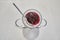 Delicious and sweet cranberry yogurt dessert served in a small bowl with a silver spoon