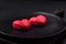 Delicious sweet heart shaped chocolate candies on a dark concrete background