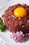 Delicious tartare of beef closeup on a white plate