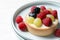 Delicious tartlet with berries on white table, closeup