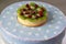 Delicious tartlet with a granatum and kiwi fruit lying on a round box.