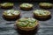 Delicious tartlets filled with cream and topped with kiwi slices