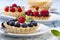 Delicious tartlets with fruit and cream mascaropne