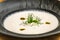 Delicious tasty creamy soup garnished with herbs