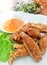 Delicious tasty Thai Golden Fried chicken wings in a plate with sauce Food background close up