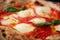 Delicious tasty traditional italian Margaret pizza (Margarita), mozzarella cheese, tomatoes, basil and crispy dough