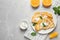 Delicious thin pancakes with oranges and cream on marble table, flat lay. Space for text