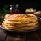 Delicious thin pancakes presented in a close up on wooden backdrop