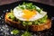 A delicious toast with guacemole and fried egg