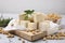 Delicious tofu cheese, rosemary and soybeans on light gray textured table, closeup