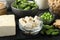 Delicious tofu and other organic soy products on black table, closeup