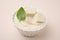 Delicious tofu sauce and basil leaf in bowl on beige background