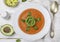 Delicious tomato soup with avocado, fresh Basil, olive oil