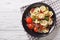 Delicious tortellini with ham, tomatoes and cheese close-up. ho