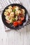 Delicious tortellini with ham, tomatoes and cheese close-up. Vertical top view