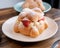 Delicious traditional mexican pan de muerto, filled with delicious cream, with red fruits inside, strawberries and blackberries