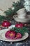 Delicious trendy mousse berry cake with honey filling on holiday table decorated with plate and cup set Fir tree Pine Cone. Home P