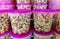 Delicious unbranded sweet and salty popcorn in plastic containers with pink lids