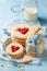 Delicious valentine cookies with red strawberries jam