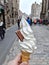 A delicious vanilla Soft serve in waffle cone in a hand Background of blur classic European street.