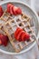 Delicious vanilla waffles with strawberry on table