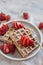 Delicious vanilla waffles with strawberry on table