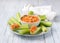 Delicious vegetable diet snack, celery stalks with carrot dip with nuts, garlic, spices and yoghurt dressing
