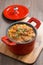 Delicious vegetable stew with sausages in a pan on wooden board