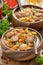 Delicious vegetable stew with sausages in a wooden bowl