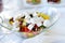 Delicious vegetables and goat cheese salad served on a party or wedding reception