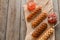 Delicious waffle corn dogs on wooden background