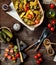 Delicious warm vegetable salad with baked potatoes, fried mushrooms, cherry tomatoes, pickles