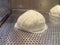 Delicious white loaf of steamed buns on the stainless shelf in the steam