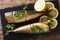 Delicious whole smoked mackerel with lemons and parsley closeup on a black slate board. Horizontal top view