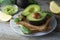 Delicious wholewheat toast with guacamole, avocado slices. Mexican cuisine. Healthy food, snack. Breakfast. Wooden rustic table